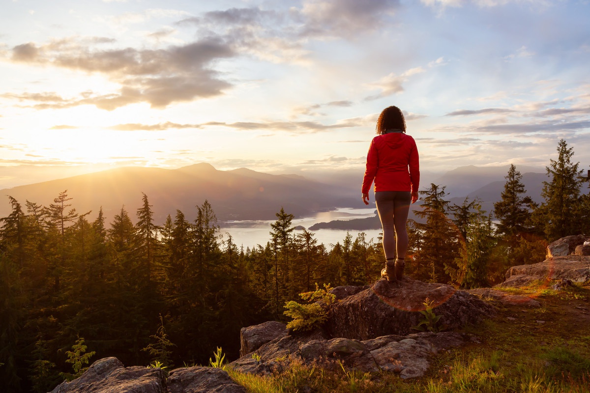 A solo hiker enjoys a view of mountains in British Columbia.