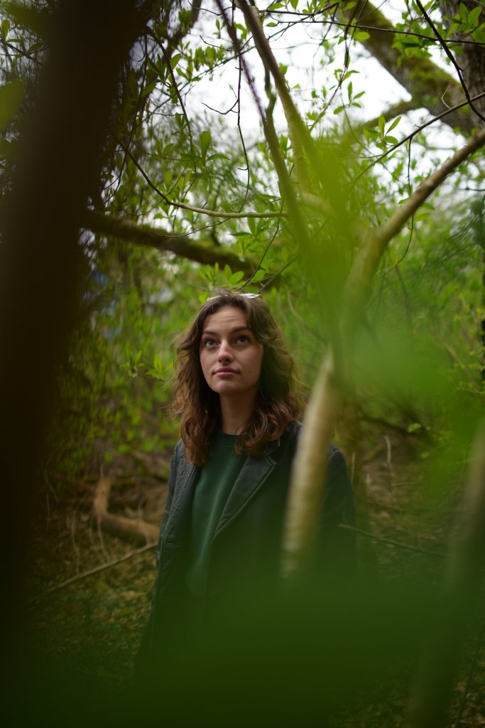 Kennedy Halwa stands in the forest.