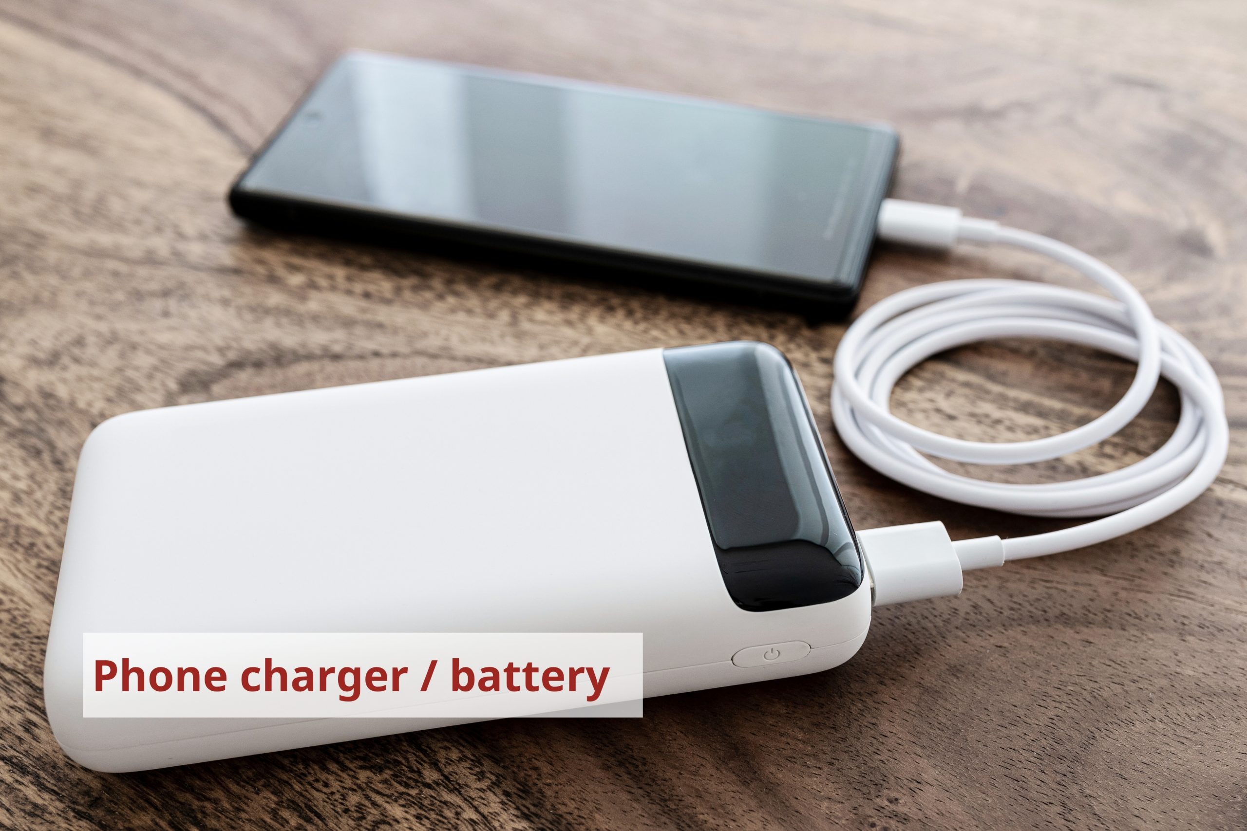 Smartphone charging using a white portable battery. Credit: Christian Horz.