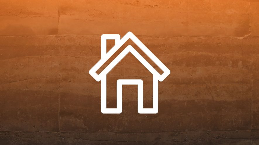 Rammed earth wall with an orange gradient and icon of a house overlaid. Photo credit: Neosiam