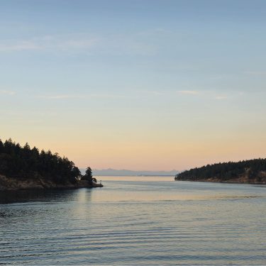 View of Vancouver Island from an early evening ferry ride. Photo credit: Gabrielle Wong