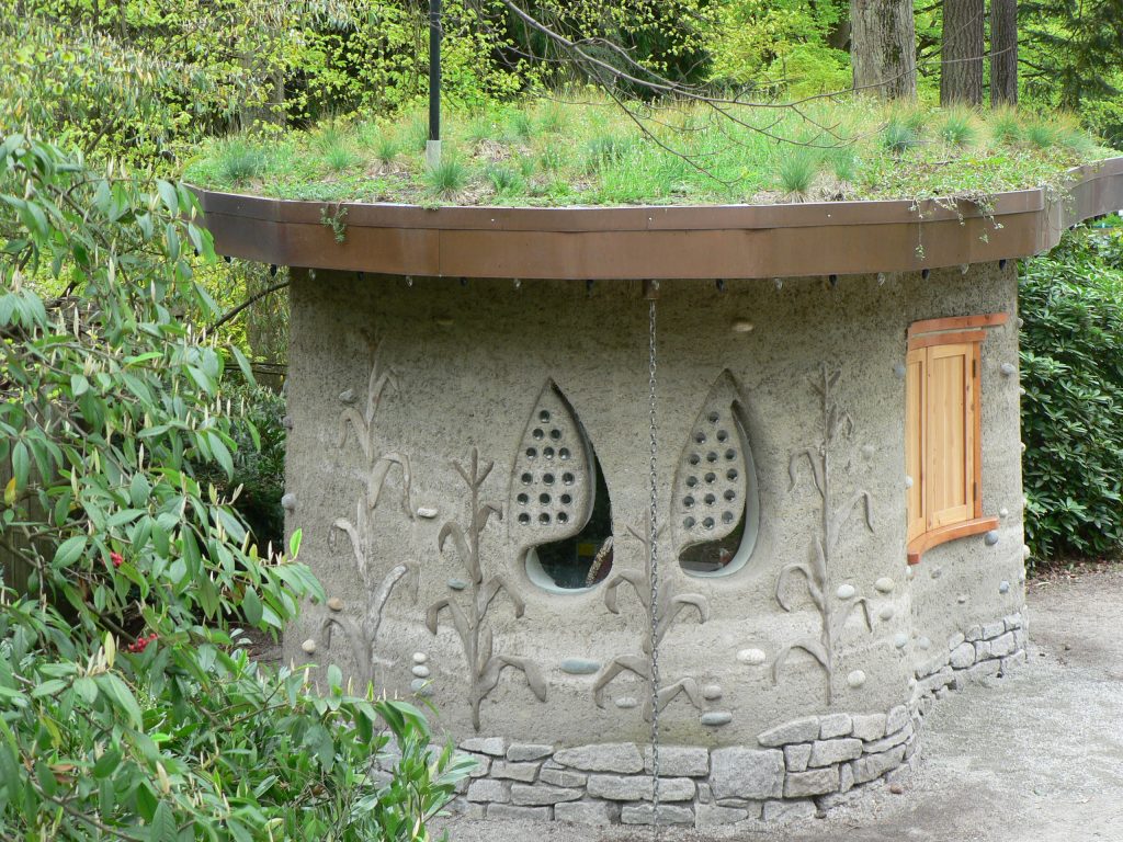 The Cob House at Stanley Park. Oblong-sharped house made of cob with corn stalk designs sculpted from the walls. Photo credit: Patricia Thompson, courtesy of Stanley Park Ecology. 